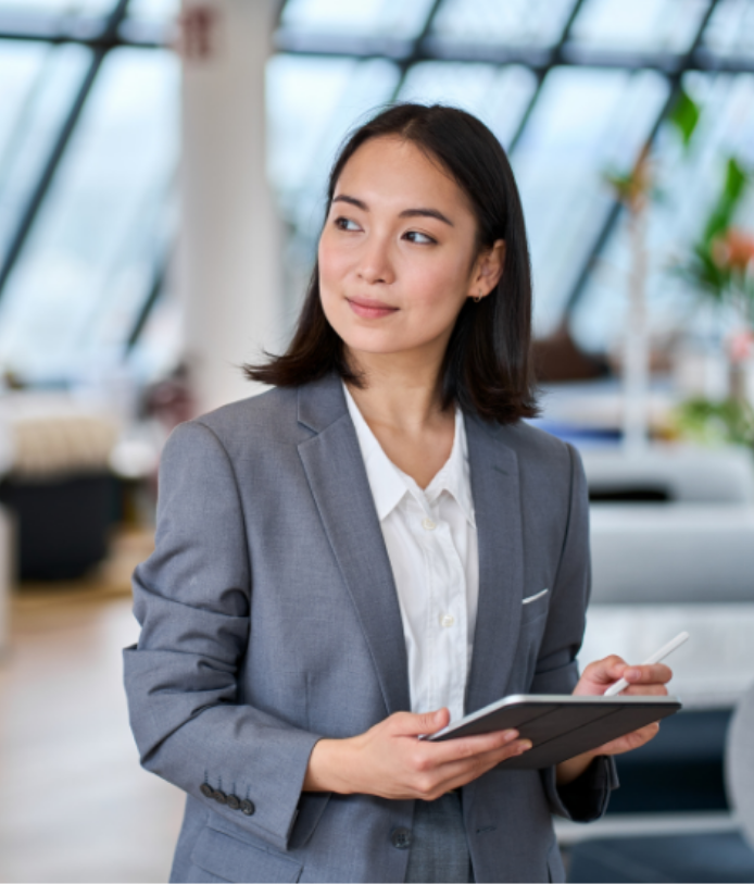 Professional woman holding a tablet in a modern office at Talent Titan, showcasing candidate predictometer software for post-offer ghosting prevention
